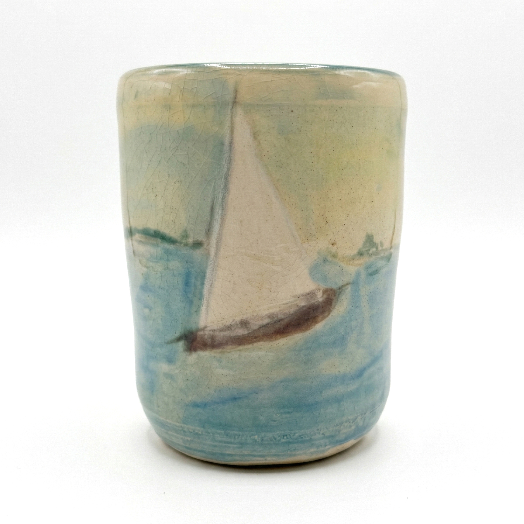 Handmade vase with painted sailboat on blue water